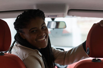 Portrait of smiling man sitting in car