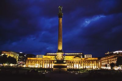 Low angle view of illuminated building against cloudy sky