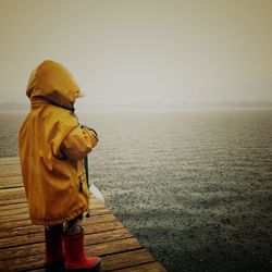 Rear view of woman standing in water