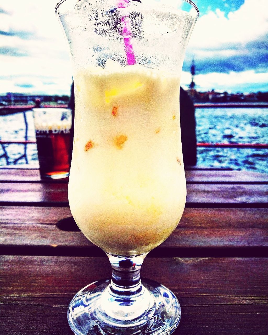 CLOSE-UP OF BEER ON TABLE AGAINST SKY