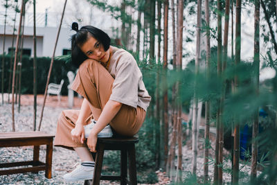 Side view of woman sitting on seat