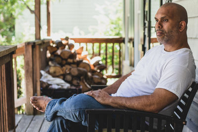 Thoughtful man sitting on chair indoors