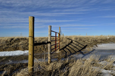 Fence on field against sky