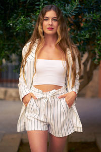 Portrait of young woman standing outdoors