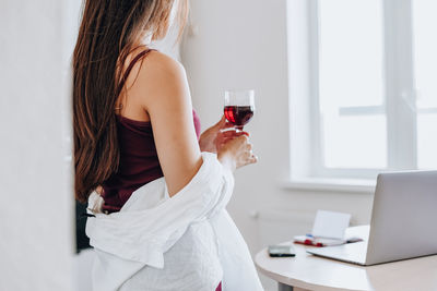 Midsection of woman using mobile phone