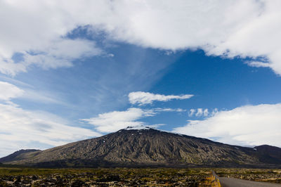 View of volcanic landscape against cloudy sky