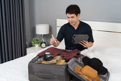 Portrait of young woman using laptop at home