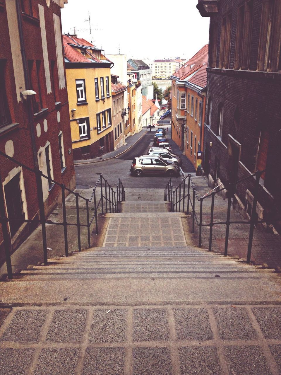 architecture, built structure, building exterior, the way forward, steps, clear sky, building, city, railing, residential building, incidental people, street, steps and staircases, transportation, residential structure, diminishing perspective, staircase, empty, day, outdoors