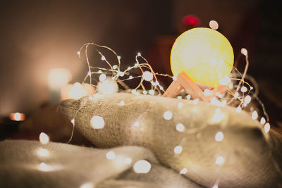 Close up moon lamp with light bulb garland concept photo