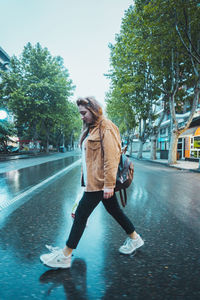 Full length of woman on road in city