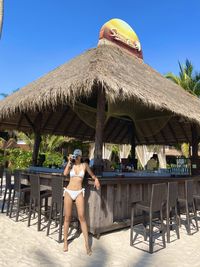 Rear view of woman sitting at beach
