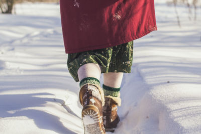 Close up female cozy style boots walking on fresh snow concept photo