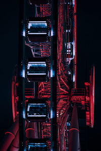 Low angle view of illuminated ferris wheel at night