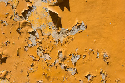 Peeling orange paint on a vintage wall