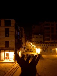 Man on illuminated city against sky at night