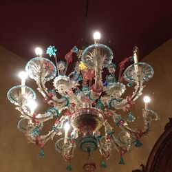 Low angle view of illuminated chandelier hanging from ceiling