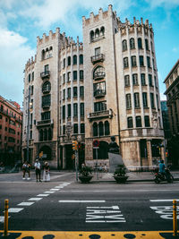 View of city street and buildings against sky