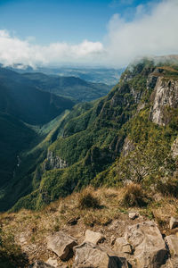 Fortaleza canyon with steep rocky cliffs and forest in a cloudy day near cambará do sul. brazil.