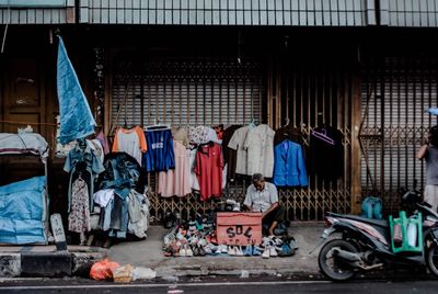 Clothes hanging at market stall in city