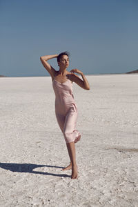 Woman on a dried up salt lake in a pink dress in the crimea