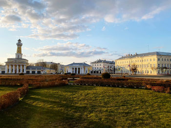 Buildings in city against cloudy sky