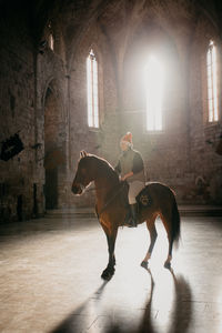 Side view of horse standing in tunnel