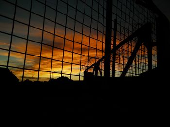 Low angle view of silhouette building against sky