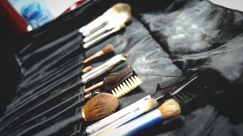 Close-up of make-up brushes in bag