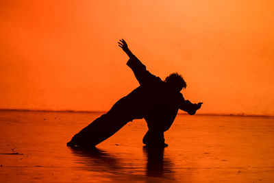 Silhouette woman standing on beach