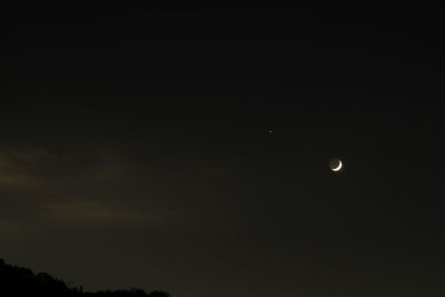 Low angle view of moon against sky at night