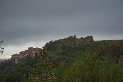 Buildings on mountain against sky