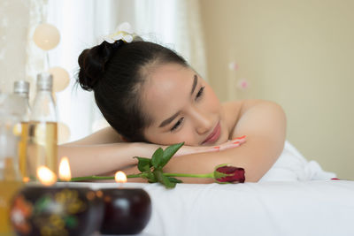 Young woman lying on massage table in spa