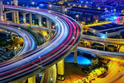 High angle view of light trails on bridge in city at night