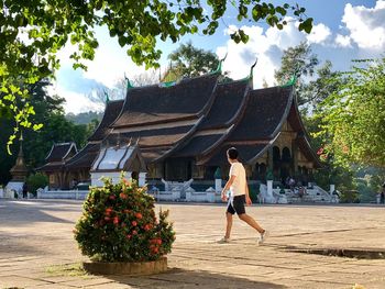 Side view of man walking on footpath