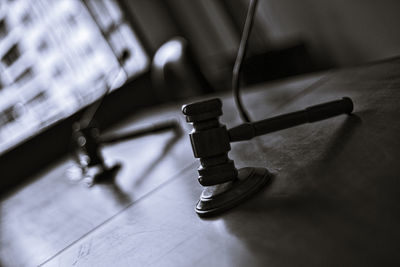 Close-up of gavel with hammer on table