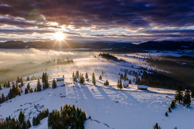 Scenic view of snow covered landscape against sky