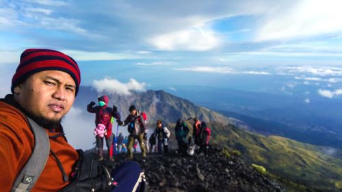 Panoramic view of man and mountains against sky