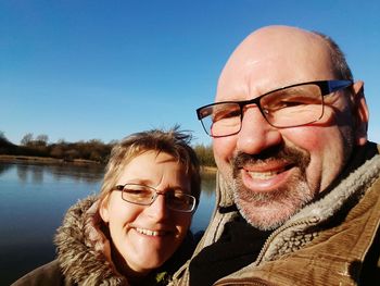 Portrait of smiling couple against sky