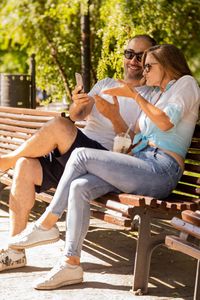 Couple sitting on bench in park