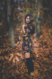 Full length of woman standing in forest