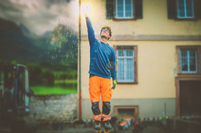 Man standing in front of built structure