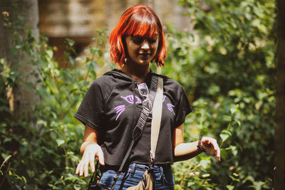 Full length of woman standing against plants