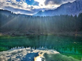 Scenic view of lake by trees against sky