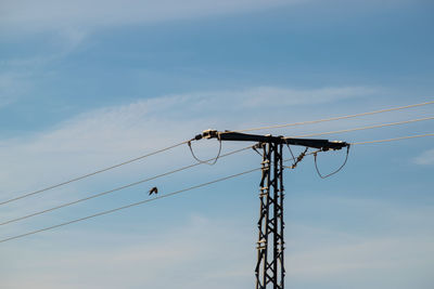 Low angle view of crane against sky