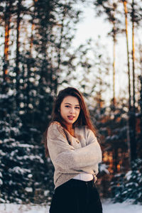 Portrait of beautiful young woman in forest