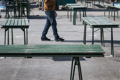 Low section of man standing on bench