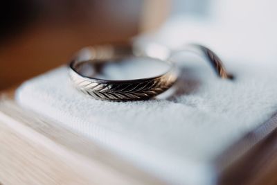 Close-up of wedding rings on table