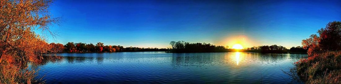 Scenic view of lake at sunset