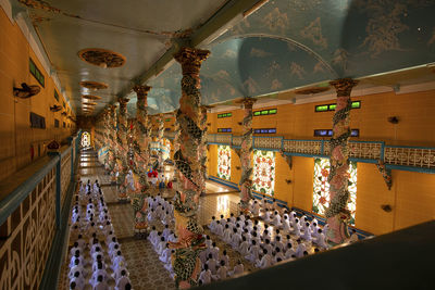 Low angle view of illuminated chandelier hanging in building