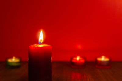 Close-up of lit candle in the dark